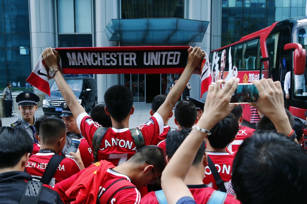 Manchester United fans at the team hotel in Beijing after the match was called off with Manchester City. Photo: Reuters