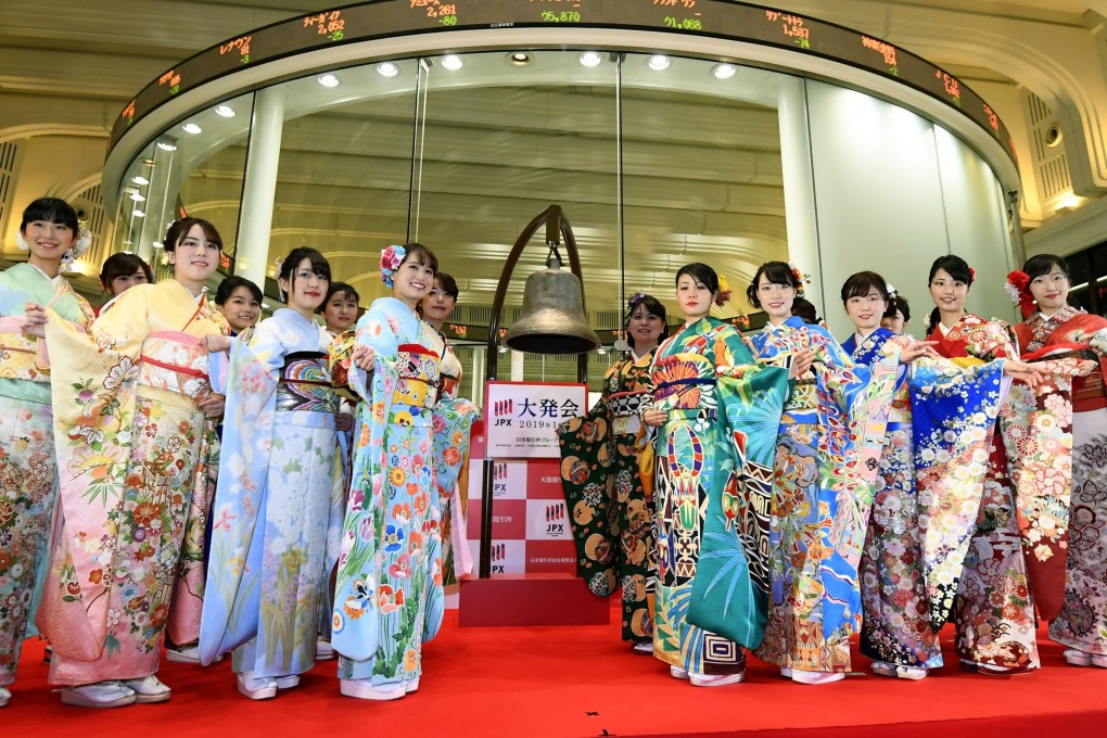 Employees of the Tokyo Stock Exchange and models in kimonos celebrate the first trading day of the year on January 4. Photo: Kyodo