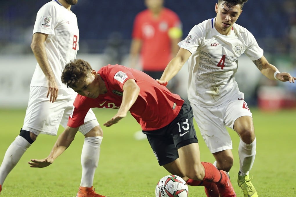 South Korea's midfielder Koo Ja-Cheol (centre) is fouled by Philippines midfielder John-Patrick Strauss during the AFC Asian Cup group C match. Photo: AP