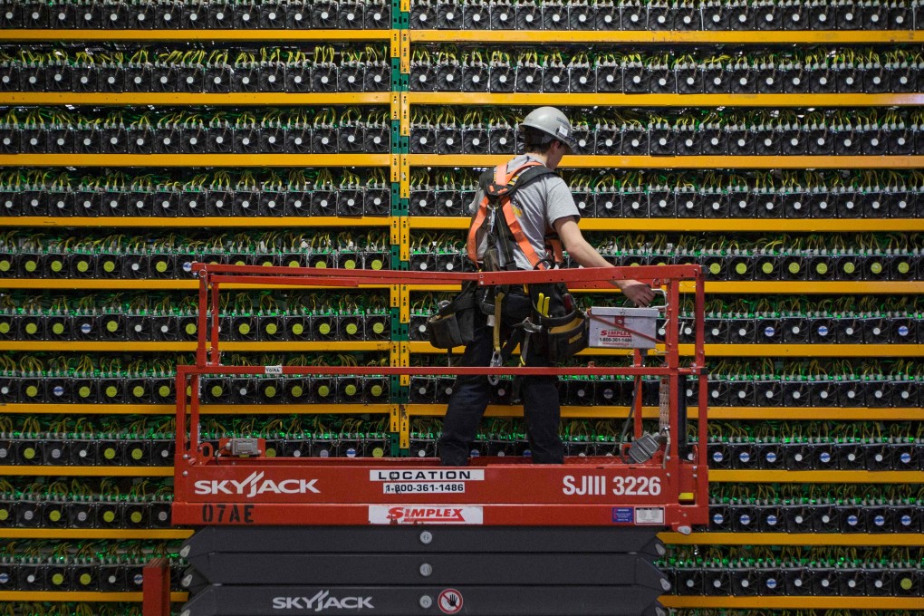 A technician inspects the backside of a network of bitcoin mining rigs. Canaan Creative, the world’s second biggest maker of cryptocurrency mining machines, is looking to list in the US after its initial public offering application in Hong Kong lapsed in November. Photo: Agence France-Presse