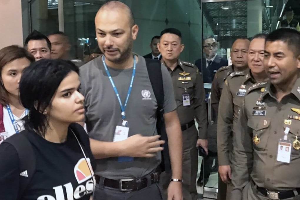 A handout photo made available by the Thai Immigration Bureau shows Saudi asylum seeker Rahaf Mohammed al-Qunun (left) with Thai Immigration Police Chief Surachet Hakparn (right) outside her Bangkok airport hotel room late Monday. Photo: EPA