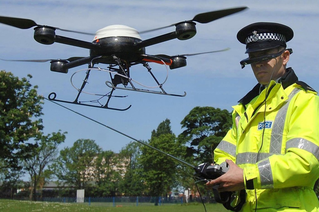 A Merseyside Police officer operating a surveillance drone in Liverpool, England. File photo: AP