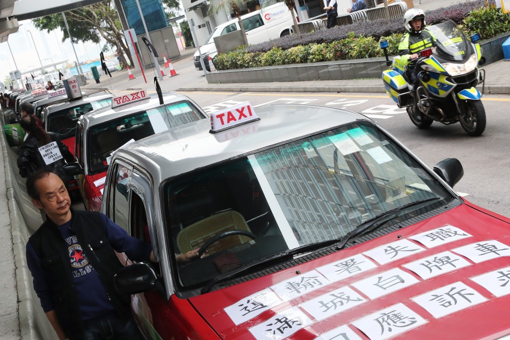 A cabby at a slow drive protest by 100 taxis in March last year protesting against the government's ‘perfunctory’ enforcement against illegal ride-hailing services such as Uber. Photo: K.Y. Cheng
