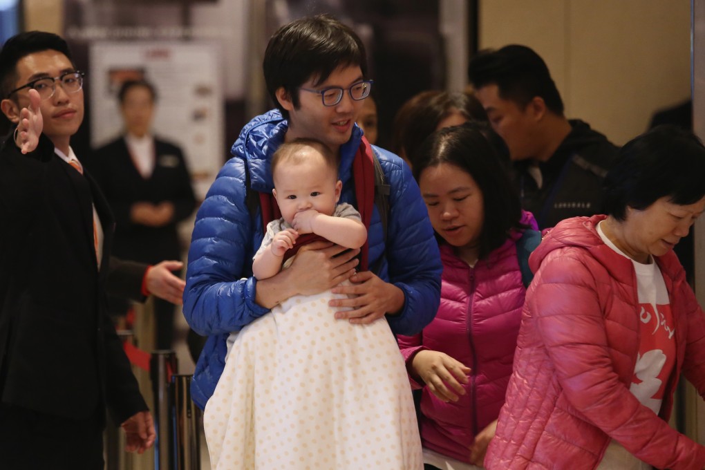 Potential buyers line up for the residential property sale in Kwun Tong in Tsim Sha Tsui on December 23. Some cite the city’s high cost of housing as one of the factors contributing to its low fertility rate. Photo: Jonathan Wong