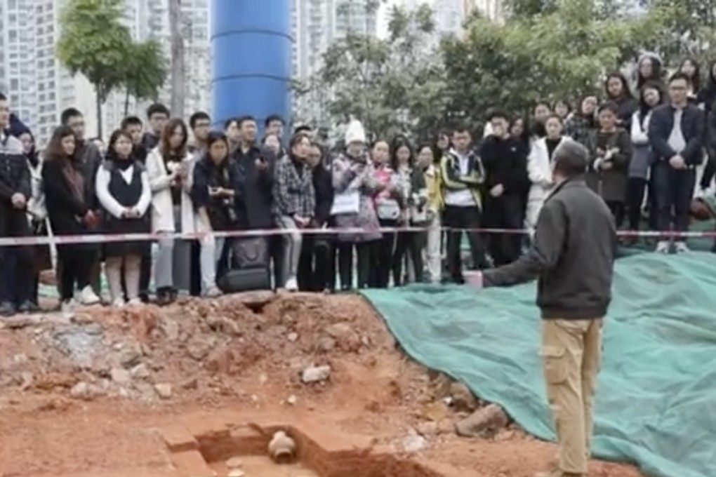 Students at Guangzhou’s Sun Yat-sen University listen to an archaeology lecture beside the tombs discovered on campus. Photo: Guancha.cn