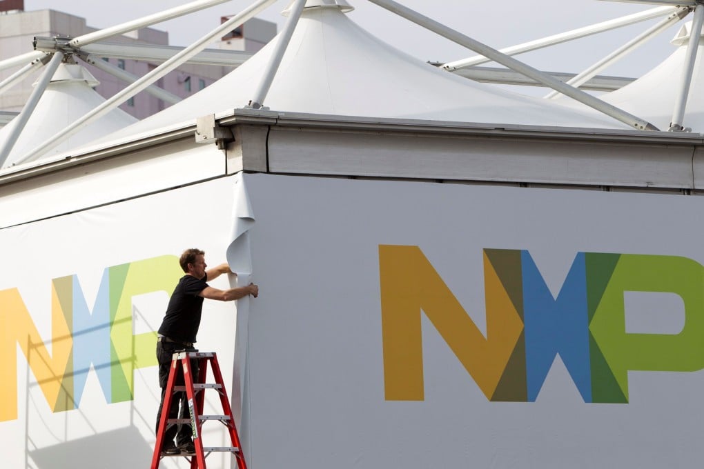 FILE PHOTO: A man works on a tent for NXP Semiconductors at Las Vegas Convention Center in Las Vegas, Nevada, US on January 4, 2015. Photo: Reuters