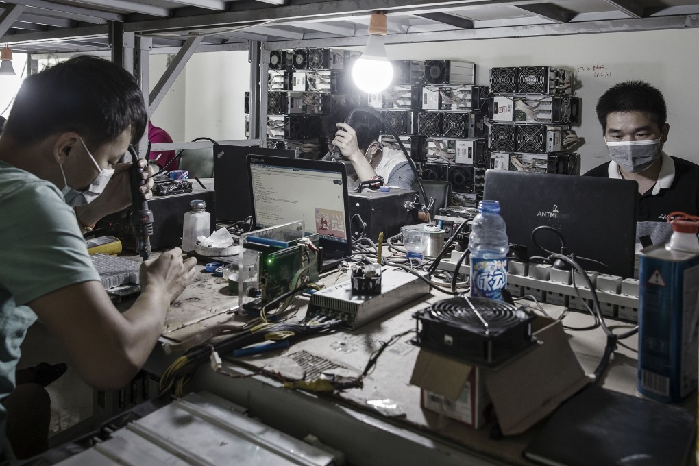 Technicians make repairs to bitcoin mining machines at a mining facility operated by Bitmain in Ordos, Inner Mongolia. Photo: Bloomberg