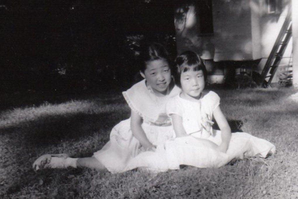 Eugenia Kim (right), author of The Kinship of secrets, with her sister Sun, in 1958. Picture: courtesy of Eugenia Kim