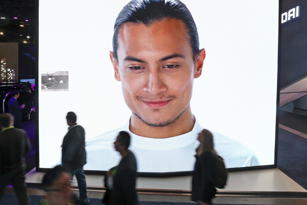 A giant KIA video screen advertises facial recognition in prototype vehicles as patrons walk past at this year’s edition of the annual CES trade show in Las Vegas. Photo: AP