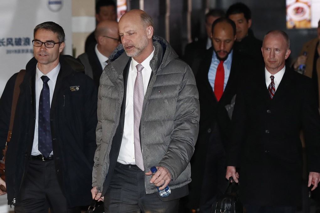 Deputy US trade representative Jeffrey Gerrish, at right, walks with other delegates as they leave a hotel in Beijing on Tuesday. Photo: EPA-EFE
