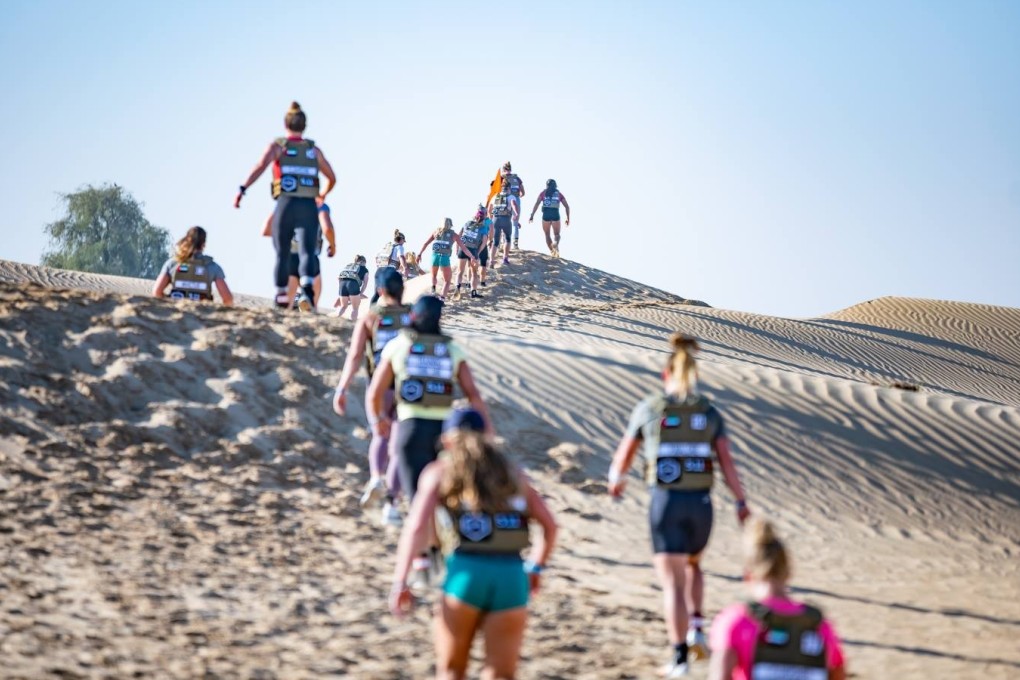 Female CrossFit athletes compete in a desert run in the first qualifying event of the new season. Photo: Dubai CrossFit Championship