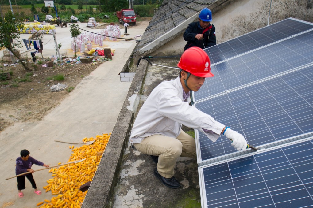 Solar panels are fixed on a roof in Hefei, capital of east China’s Anhui province. China in May last year cut subsidies for solar farm operators. Photo: Xinhua