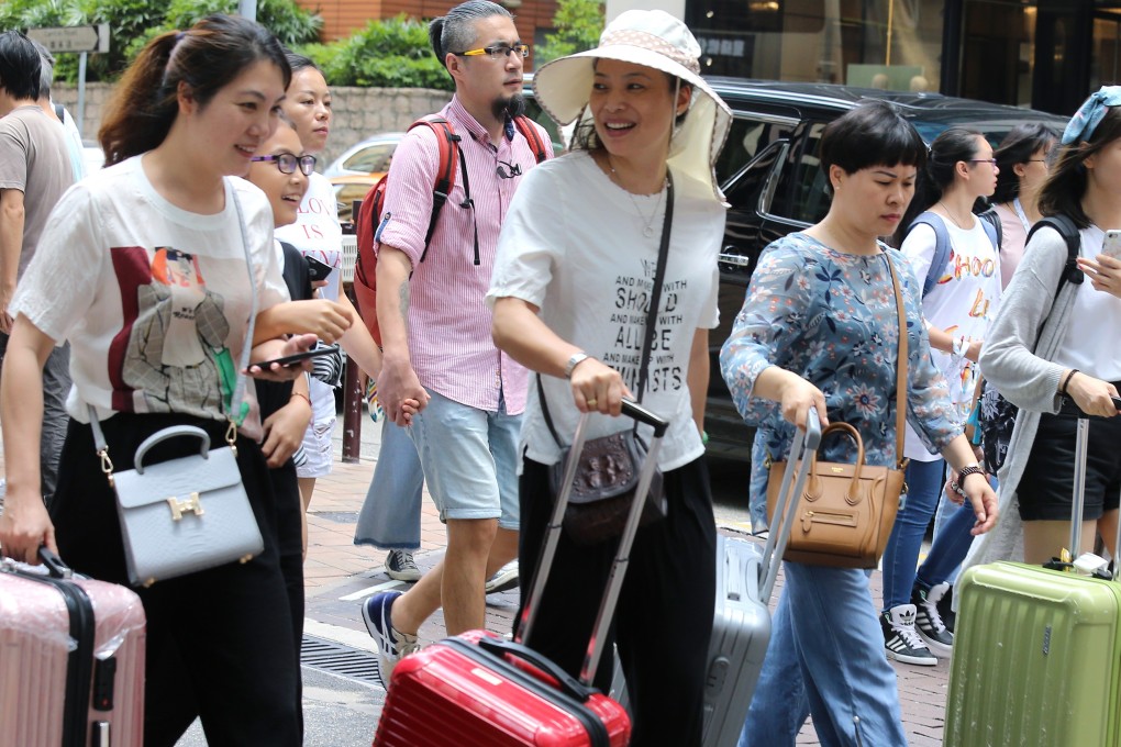 Chinese consumers have become thrifty at home, but abroad they are as spendthrift as ever. Photo: Dickson Lee