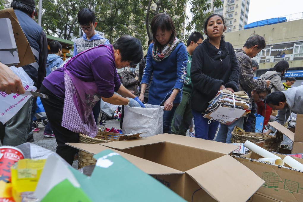Residents at a community recycling event organised by Waste-no-mall gather items for recycling at Fung Yau Path in Yuen Long. Photo: Edmond So