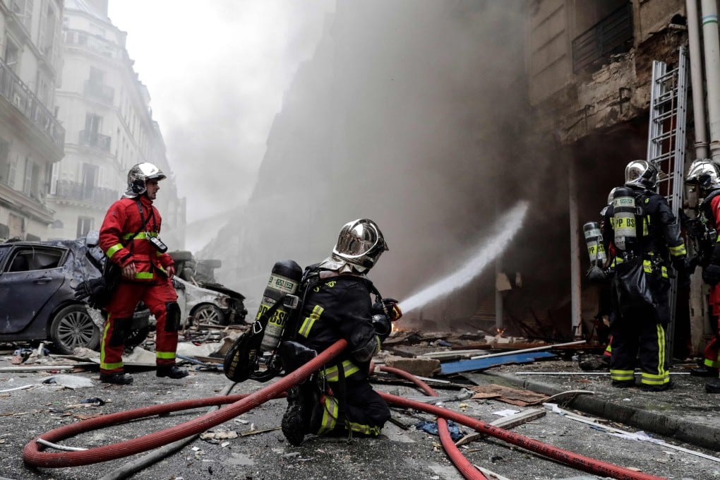 Firefighters extinguish a fire after the explosion at a bakery on the corner of the streets Saint-Cecile and Rue de Trevise in central Paris. Photo: AFP