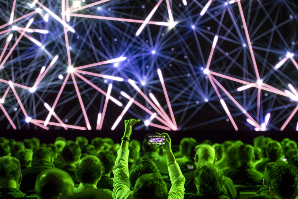 An attendee takes a photograph of the stage prior to the Nvidia Corp. event at the 2019 Consumer Electronics Show (CES) in Las Vegas on Sunday, January 6, 2019. CES showcases more than 4,500 exhibiting companies, including manufacturers, developers and suppliers of consumer technology hardware, content, technology delivery systems and more. Photo: Bloomberg
