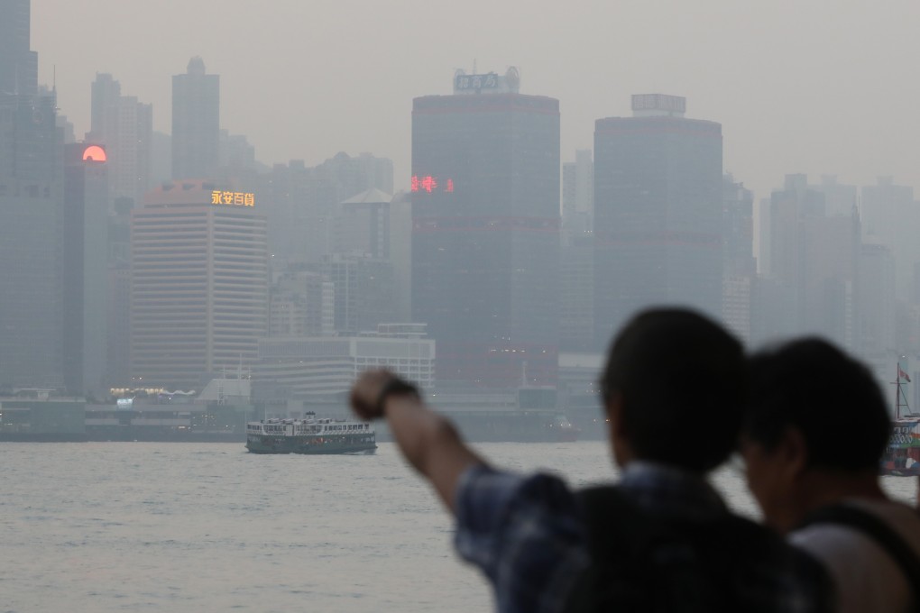 Tourists looking out on Victoria Harbour on a poor air quality day in November 2018. Photo: Sam Tsang