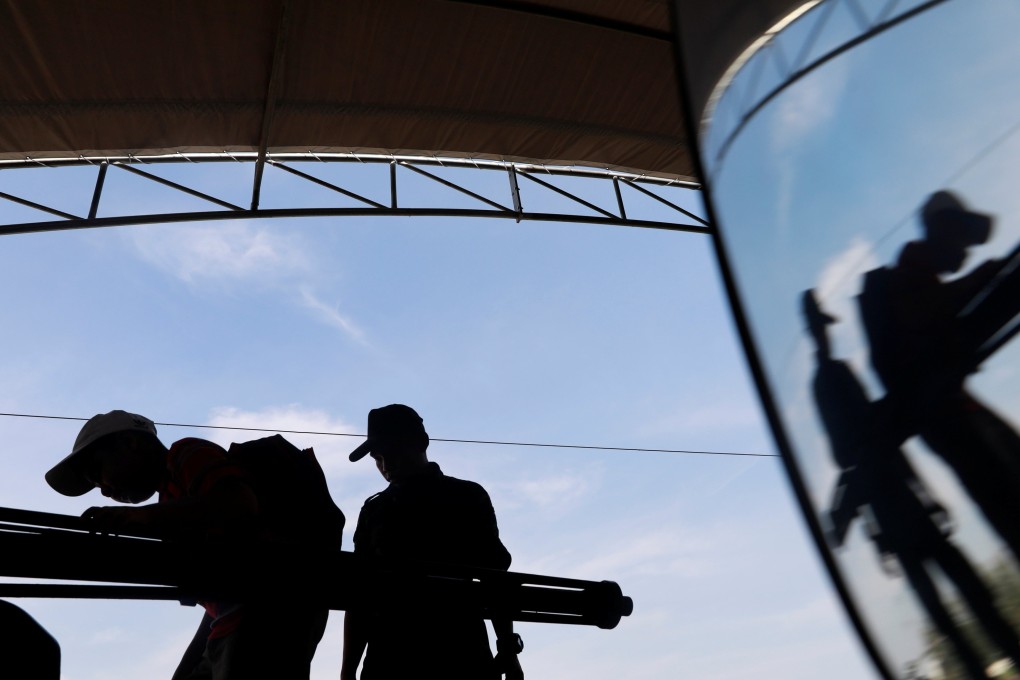 Boys play with a weapon on the top of an army vehicle during Children's Day celebration at a military facility in Bangkok, Thailand January 12, 2019. REUTERS/Soe Zeya Tun