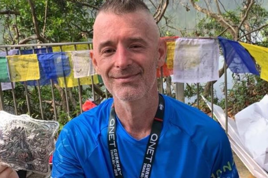 Nic Tinworth sits on the finish line of the Gurkha Trailblazer. Only seven months ago he had to re-learn how to walk, but he finished the course in under two hours. Photo: Handout