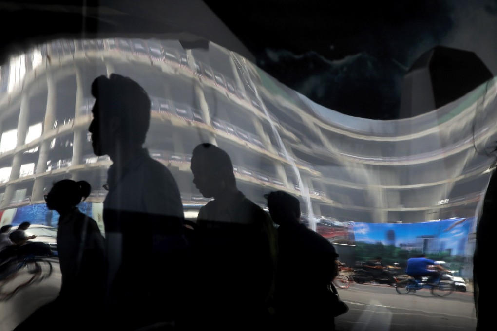 Pedestrians and motorists are reflected in an advertising billboard in the central business district in Beijing. In 2016, an aggressive fiscal stimulus package helped get the Chinese economy back on its feet after the blow of the 2015 devaluation of the renminbi. In 2019, however, the government’s deleveraging campaign is limiting the scope for more forceful measures as China’s manufacturing sector slows. Photo: AP
