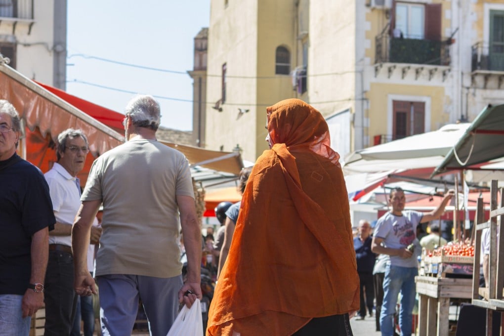 Bangladeshi market traders and customers in Balero Market, Palermo
