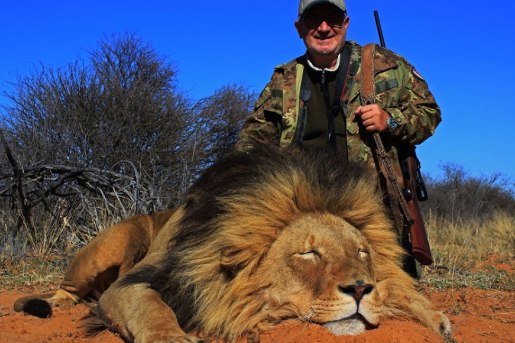 A Mkulu client next to a lion he had shot. Photo: Mkulu African Hunting Safaris