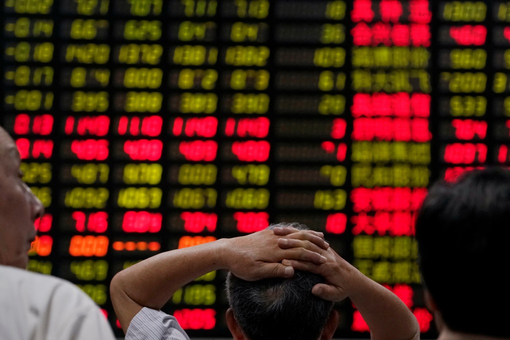 Investors look at an electronic board showing stock information at a brokerage house in Shanghai on June 20, 2018. Photo: Reuters
