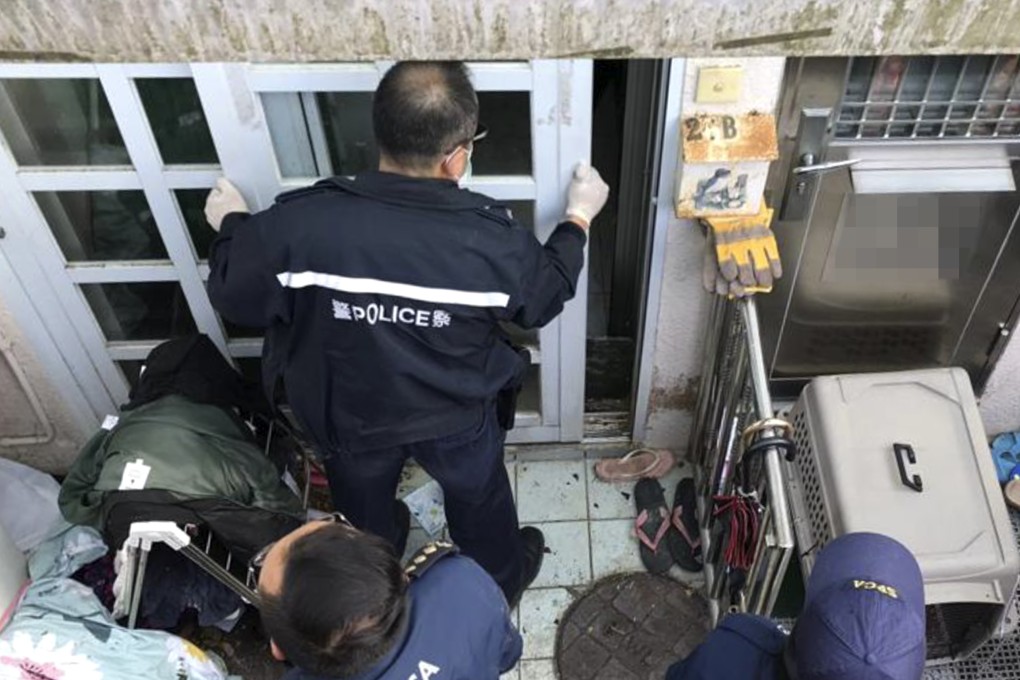 Police and fire officers enter the ground-floor flat at Tai Wan Tsuen off Tai Mong Tsai Road, Sai Kung, where 45 cats were found in a malnourished state. Photo: Handout