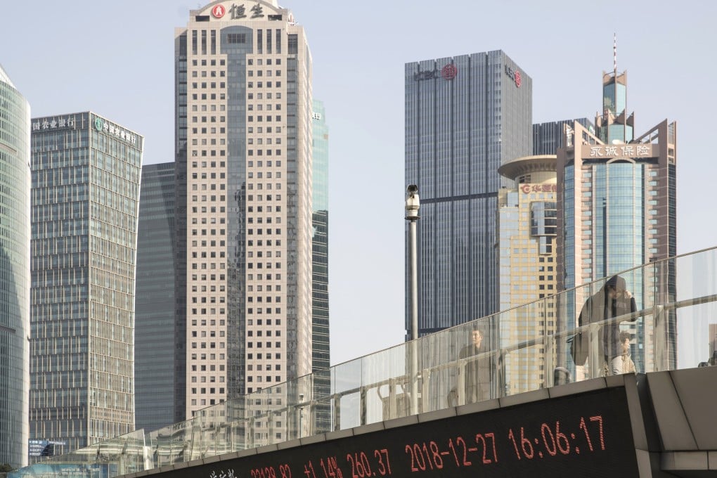 Pedestrians walk along an elevated walkway as an electronic ticker displays stock figures in Pudong's Lujiazui Financial District in Shanghai, China, on Friday, December 28, 2018. China announced plans to rein in the expansion of lending by the nation's regional banks to areas beyond their home bases, the latest step policy makers have taken to defend against financial risk in the world's second-biggest economy. Photo: Bloomberg