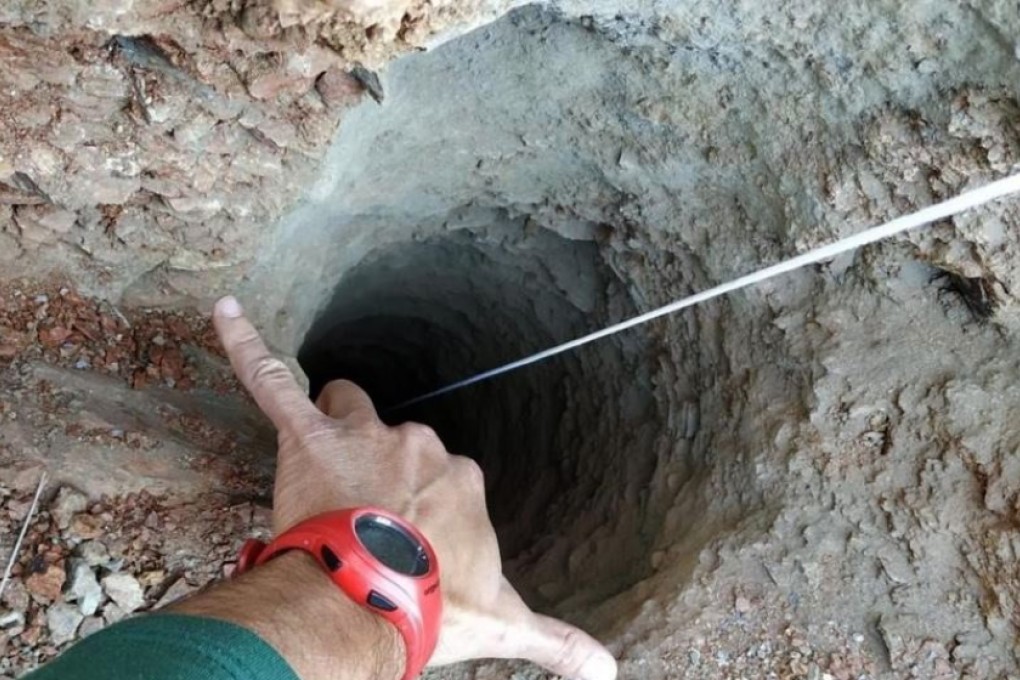The hole is about 110 metres deep (360 feet), but only 40cm at its widest spot – big enough for a toddler to slip into. Photo: EPA