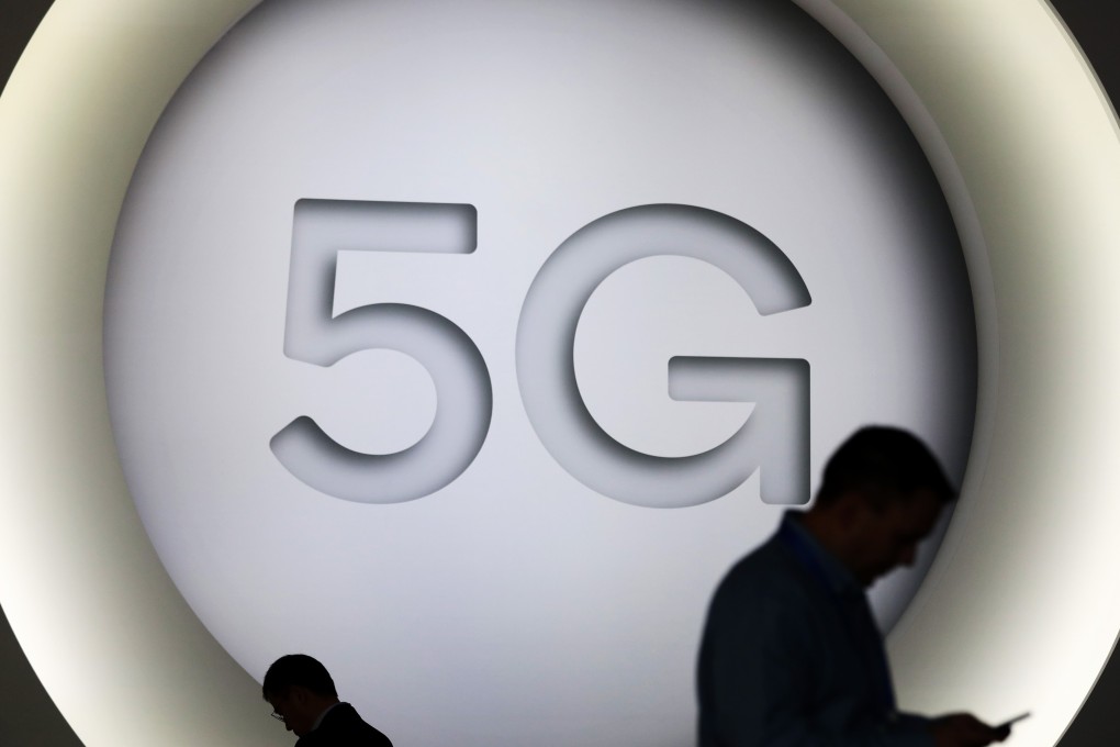 Attendees check their smartphone devices by a 5G sign during the opening day of the Mobile World Congress (MWC) in Barcelona, Spain, on Monday, February 26, 2018. At the wireless industry’s biggest conference, more than 100,000 people are set to see the latest smartphones, artificial intelligence devices and autonomous drones exhibited by roughly 2,300 companies. Photographer: Simon Dawson/Bloomberg