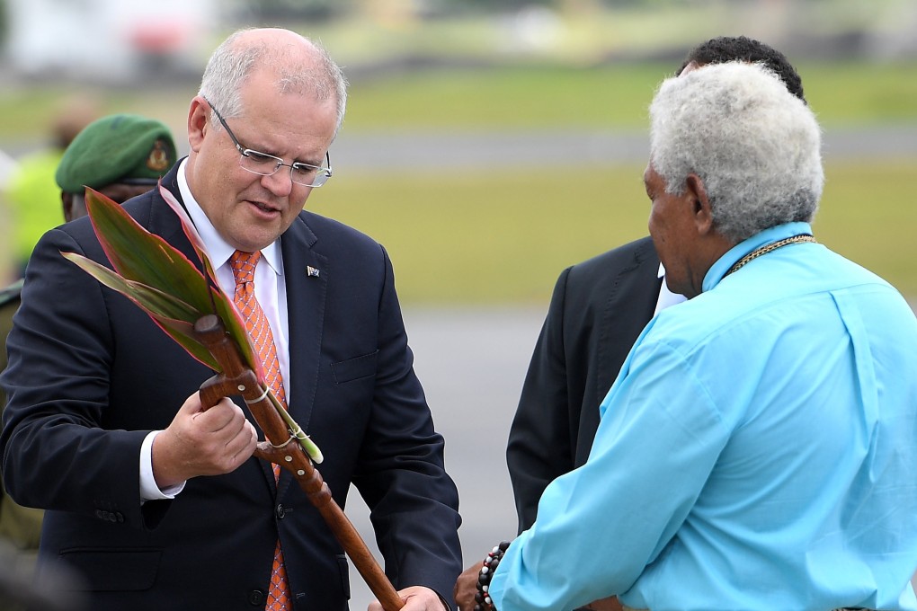 Australian Prime Minister Scott Morrison is presented with a gift as he arrives in Port Vila. Photo: Reuters