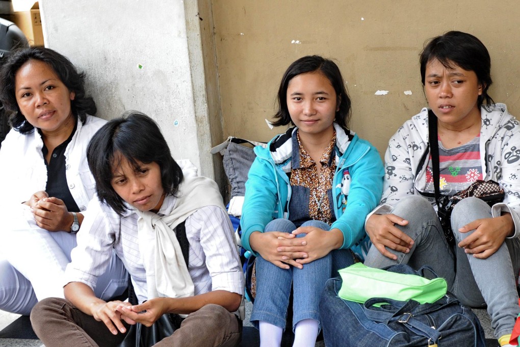 Foreign domestic workers in Singapore have reported being overworked, receiving verbal abuse, not having enough food, and having to give their employers massages. Photo: AFP