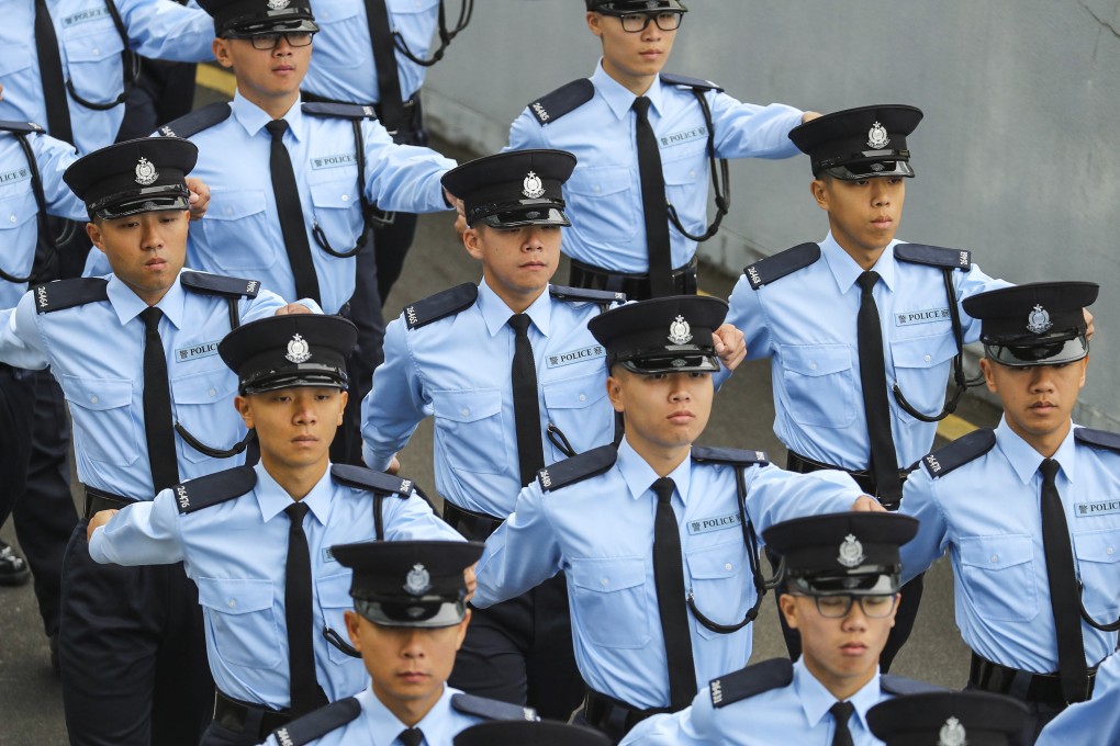 Hong Kong police officers march in a Force Remembrance Day parade, for colleagues killed while serving the community. The highest-ranked woman in the history of the city police will step down in March and become head of the Office of the Ombudsman in April. Photo: Winson Wong