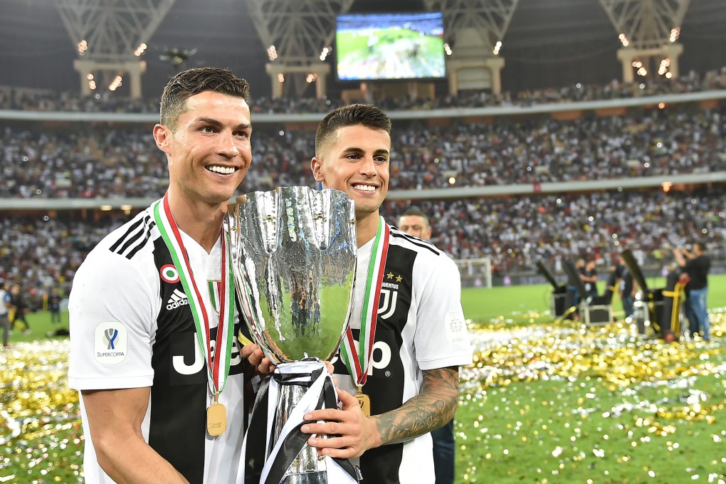 Juventus stars Cristiano Ronaldo (left) and Argentine forward Paulo Dybala celebrate with the Supercoppa trophy. Photo: EPA