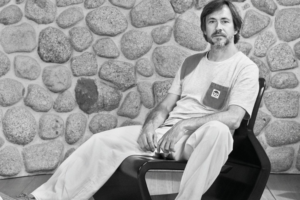 Australian designer Marc Newson in his Extruded Chair. Photo: Jorn Tomter