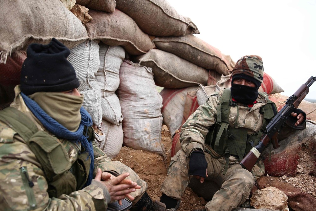 Turkish-backed Syrian opposition fighters gather in a sandbagged barricade near the village of Hamran, northwest of the northern Syrian town of Manbij. Photo: AFP