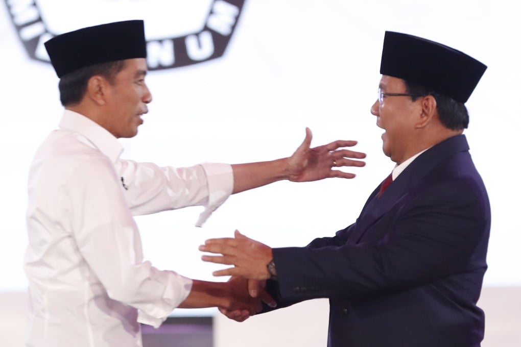 Joko Widodo (left) shakes hand with presidential candidate Prabowo Subianto before the first debate in Jakarta, Indonesia, on January 17. Photo: EPA
