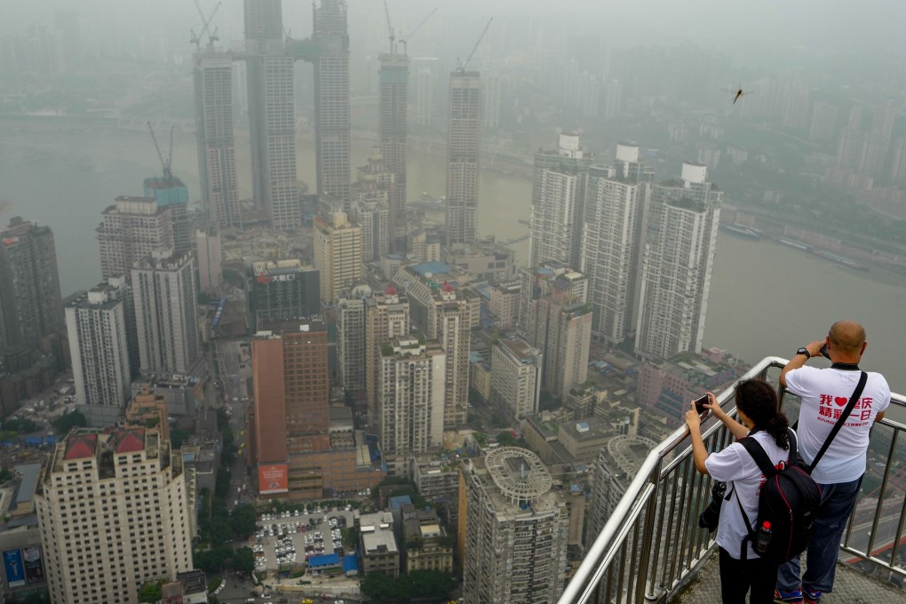 People take photos of Chongqing on June 18. A property market downturn is expected in 2019, contributing to doubts about the overall health of the world’s second-largest economy. Photo: Xinhua