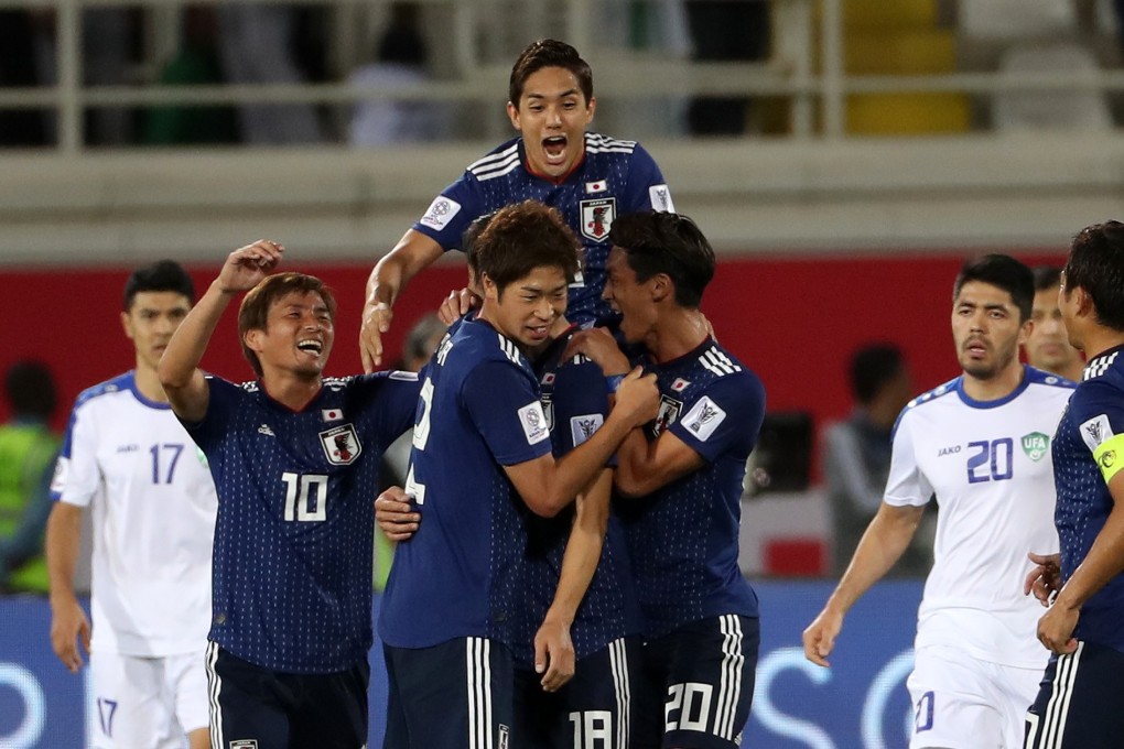 Japan players celebrate during their AFC Asian Cup group F win against Uzbekistan in the United Arab Emirates. Photo: Xinhua