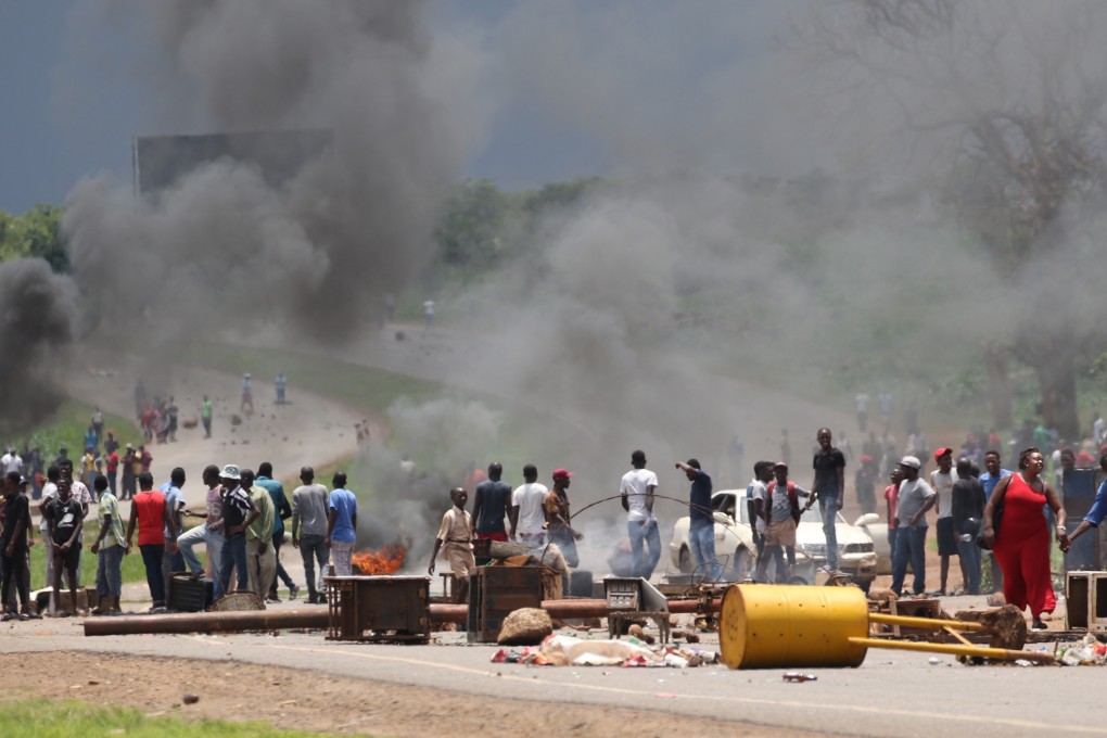 Protesters block a major road leading into the city centre in Harare, Zimbabwe, on Monday. Photo: EPA