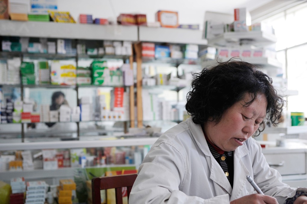 Beijing has moved to cut prices of drugs and improve their efficacy and safety. Here a woman works at the pharmacy of a state-owned hospital in a town in Hebei province, China, in this photo taken in 2008.