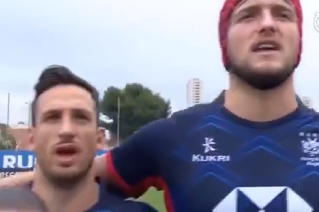 Hong Kong rugby players sing the China national anthem. Photo: Sina Sports
