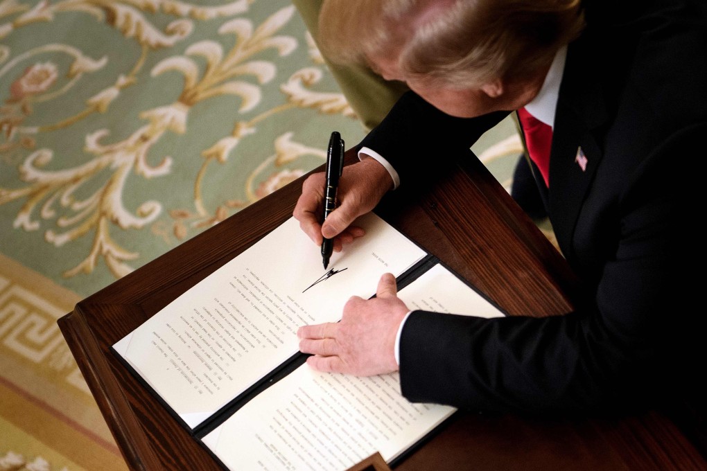 In this file photo taken on July 19, 2018, US President Donald Trump signs an executive order in the East Room of the White House. Photo: AFP