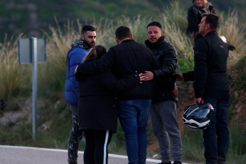 People comfort each other last week after leaving the area where Julen Rosello, a Spanish two-year-old boy, fell into a deep well six days ago as his family was taking a stroll through a private estate, in Totalan, Spain. Photo: Reuters