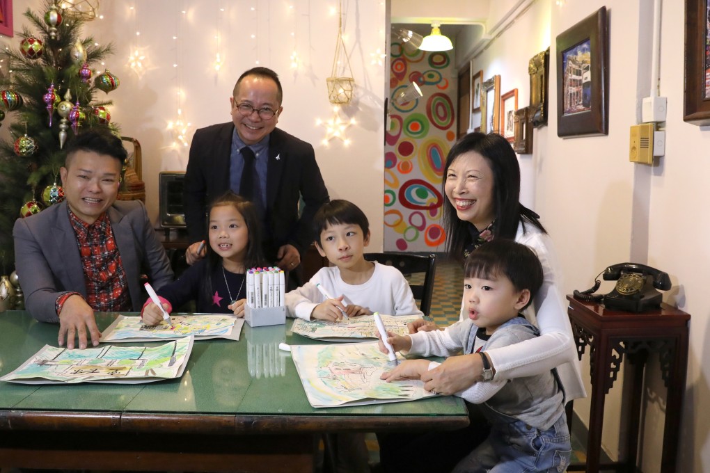 (From left) Eric Ng, artist and designer of the light home in Hung Hom; Ricky Yu, founder of Light Be social enterprise and landlord Cindy Wong with tenants’ children. Photo: Nora Tam