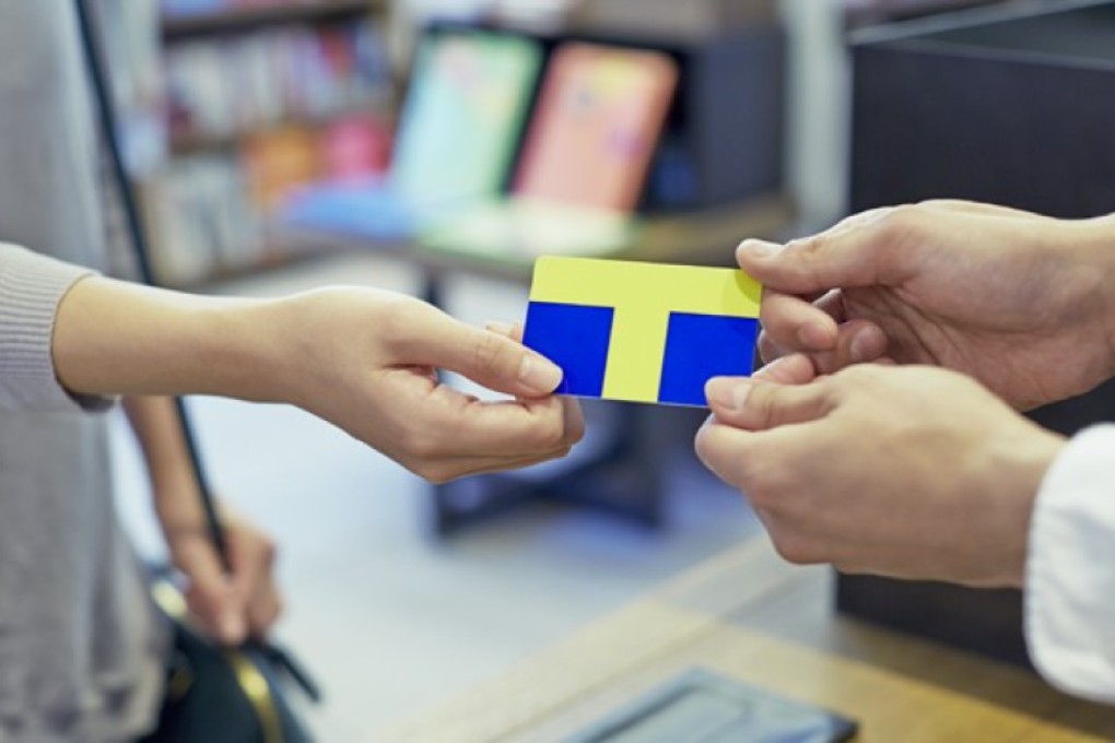 Somebody handing over a T Card, which can be used in shops all over Japan. Photo: