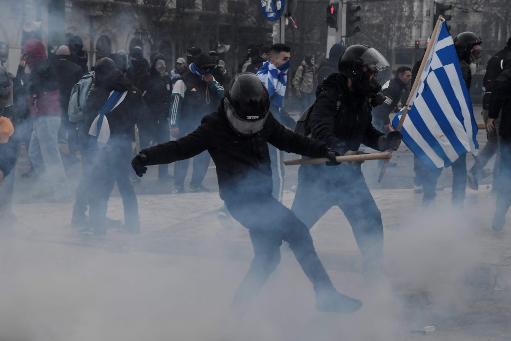 Protesters clash with police in front of the Greek parliament in Athens on Sunday. Photo: AFP