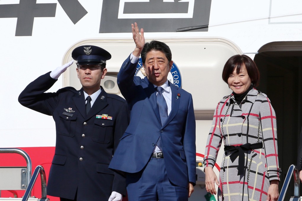 Japanese Prime Minister Shinzo Abe and his wife Aki Abe wave as they depart for Russia at Tokyo’s Haneda Airport. Photo: EPA