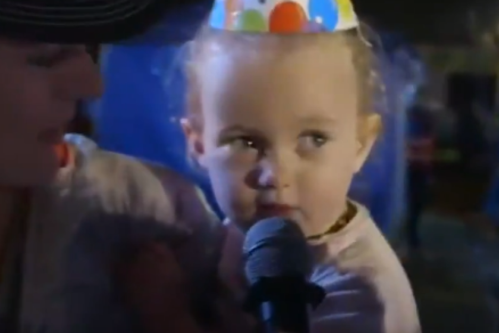 Scott Hawker's daughter sings happy birthday on the finish line of the HK100. Photo: Gone Running TV